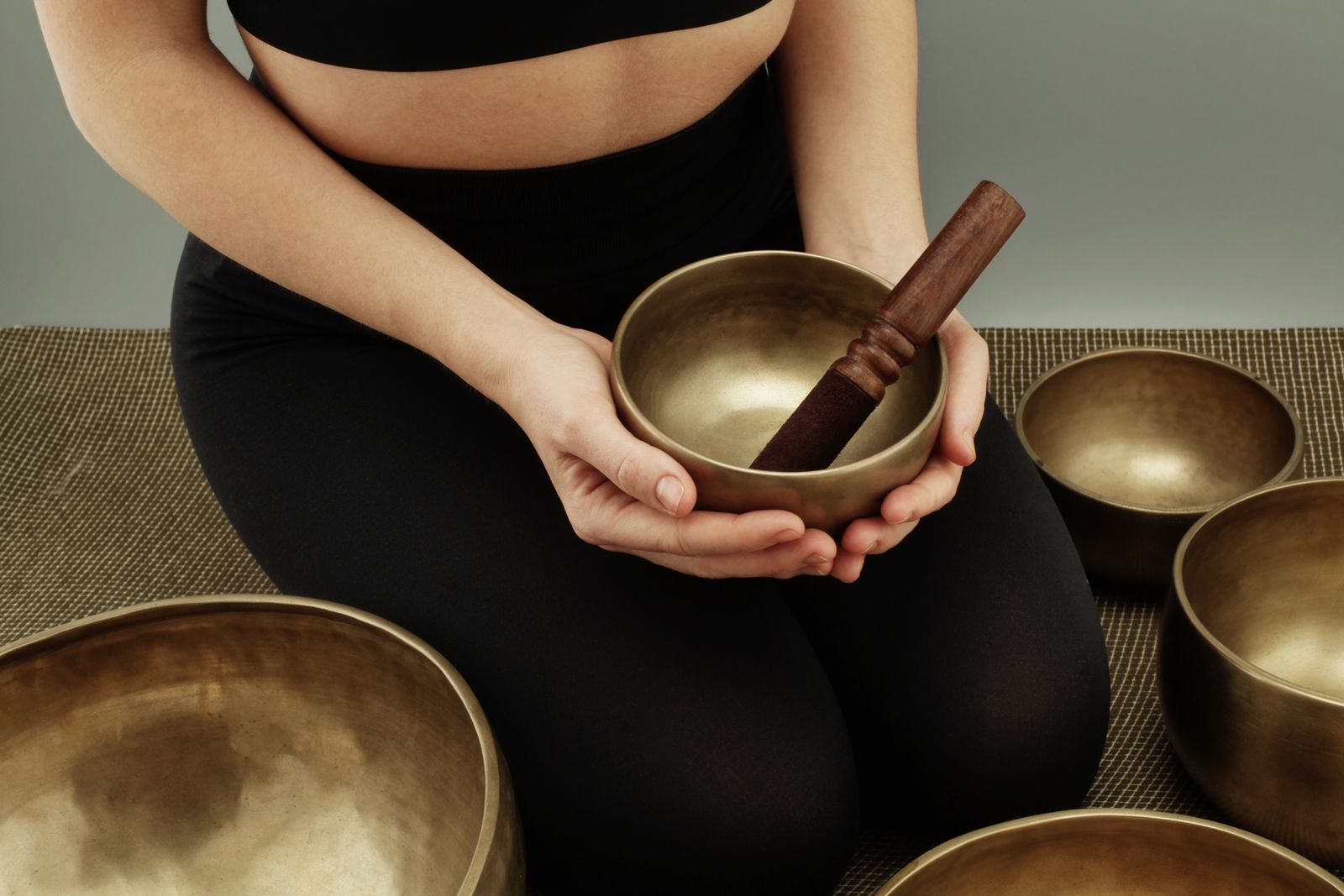A stillness practice holding a singing bowl in both hands